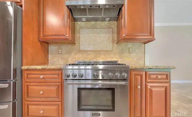 a stove top oven sitting inside of a kitchen
