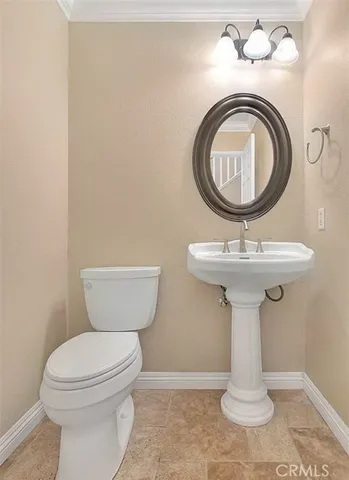 a bathroom with a sink toilet and a mirror