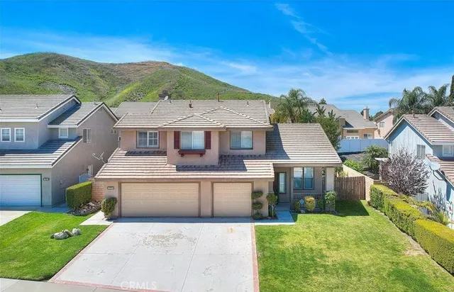 a front view of a house with a yard and palm tree