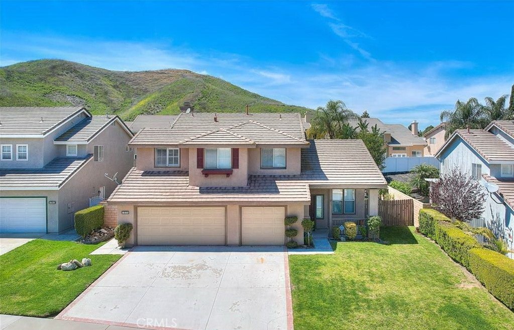 16410 Argent Road Chino Hills, CA 91709 - Photo 4 of 31 a front view of a house with a yard and palm tree