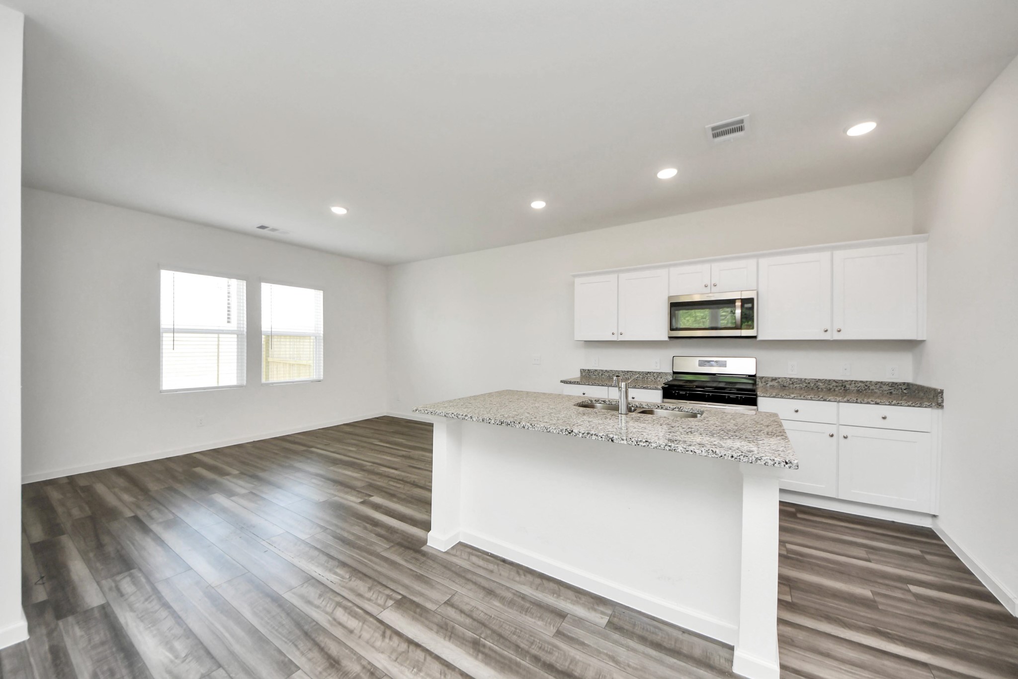 10303 Rose Mar Drive, Unit B Rosharon, TX 77583 - Photo 5 of 49 a kitchen with a stove a sink and a refrigerator