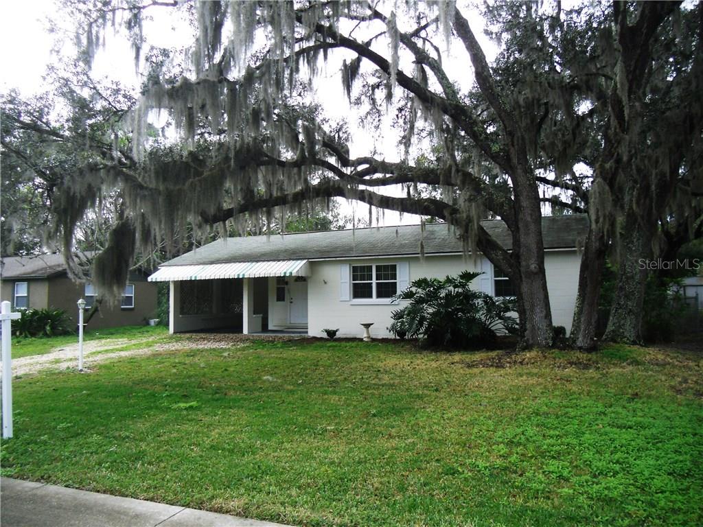 255 Valencia Road DeBary, FL 32713 - Photo 1 of 1 a view of a house with a garden and trees