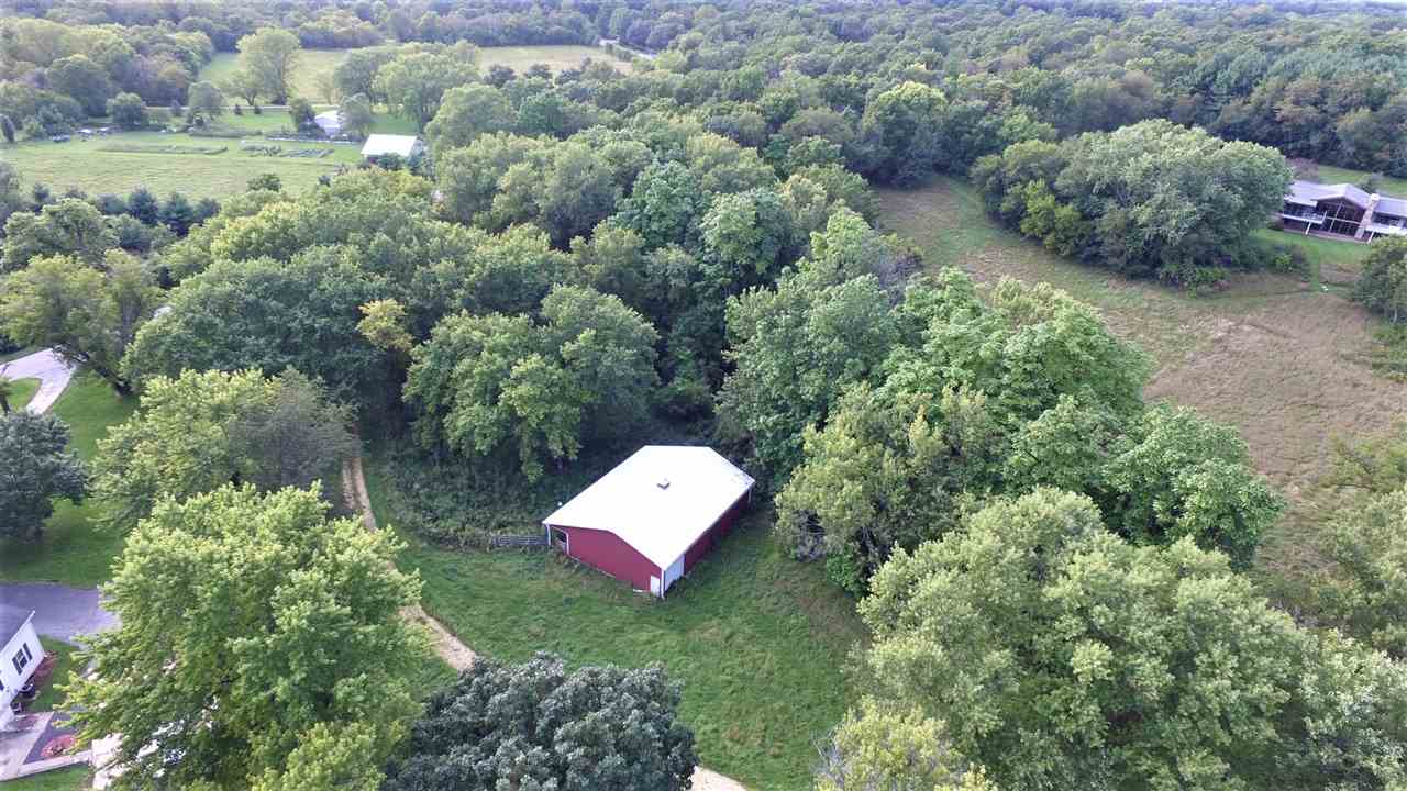 8502 Burr Oak Road Roscoe, IL 61073 - Photo 1 of 14 a backyard of a house with a yard and outdoor seating