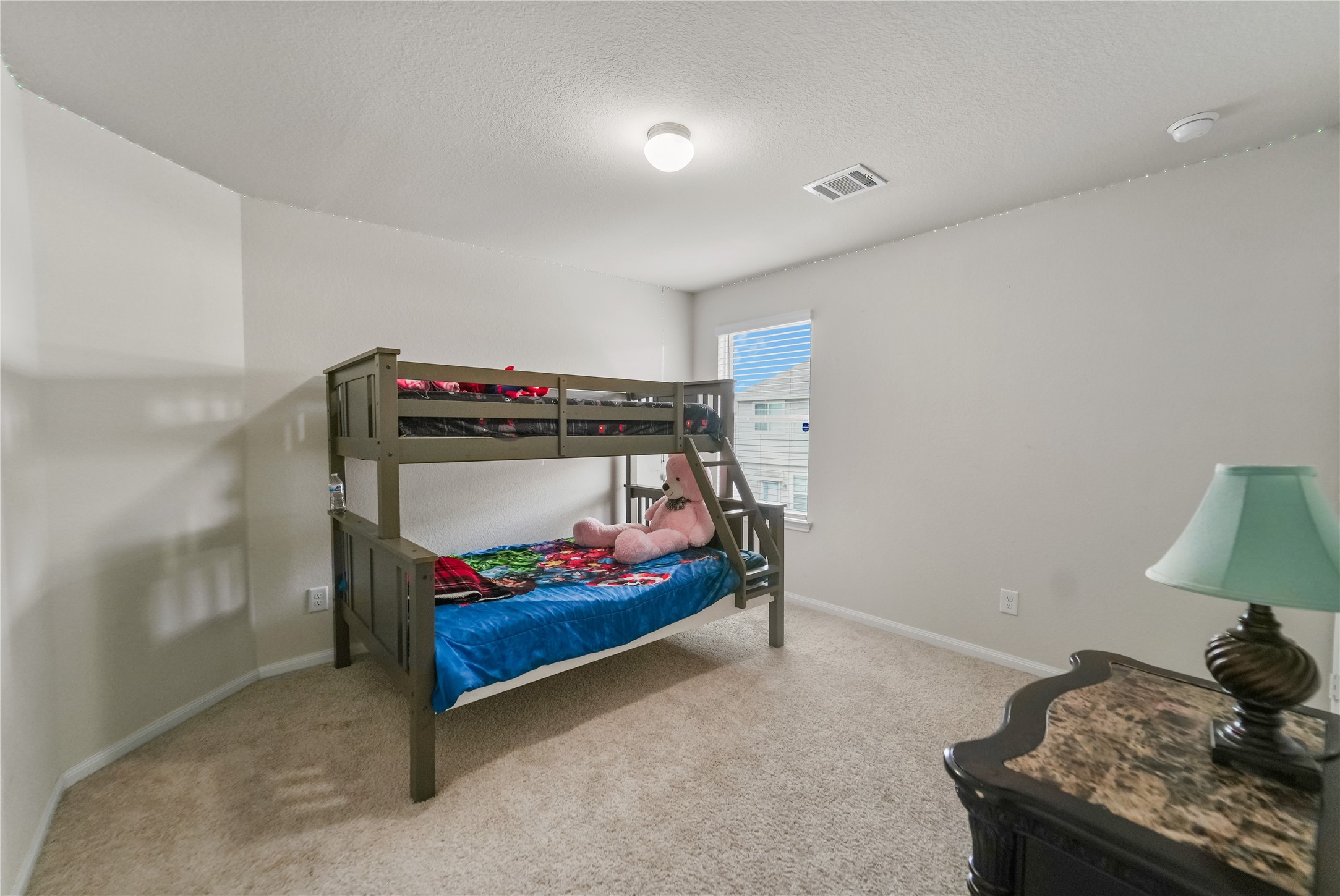 23659 Goodfellow Drive Spring, TX 77373 - Photo 16 of 25 a bedroom with a bed and a lamp