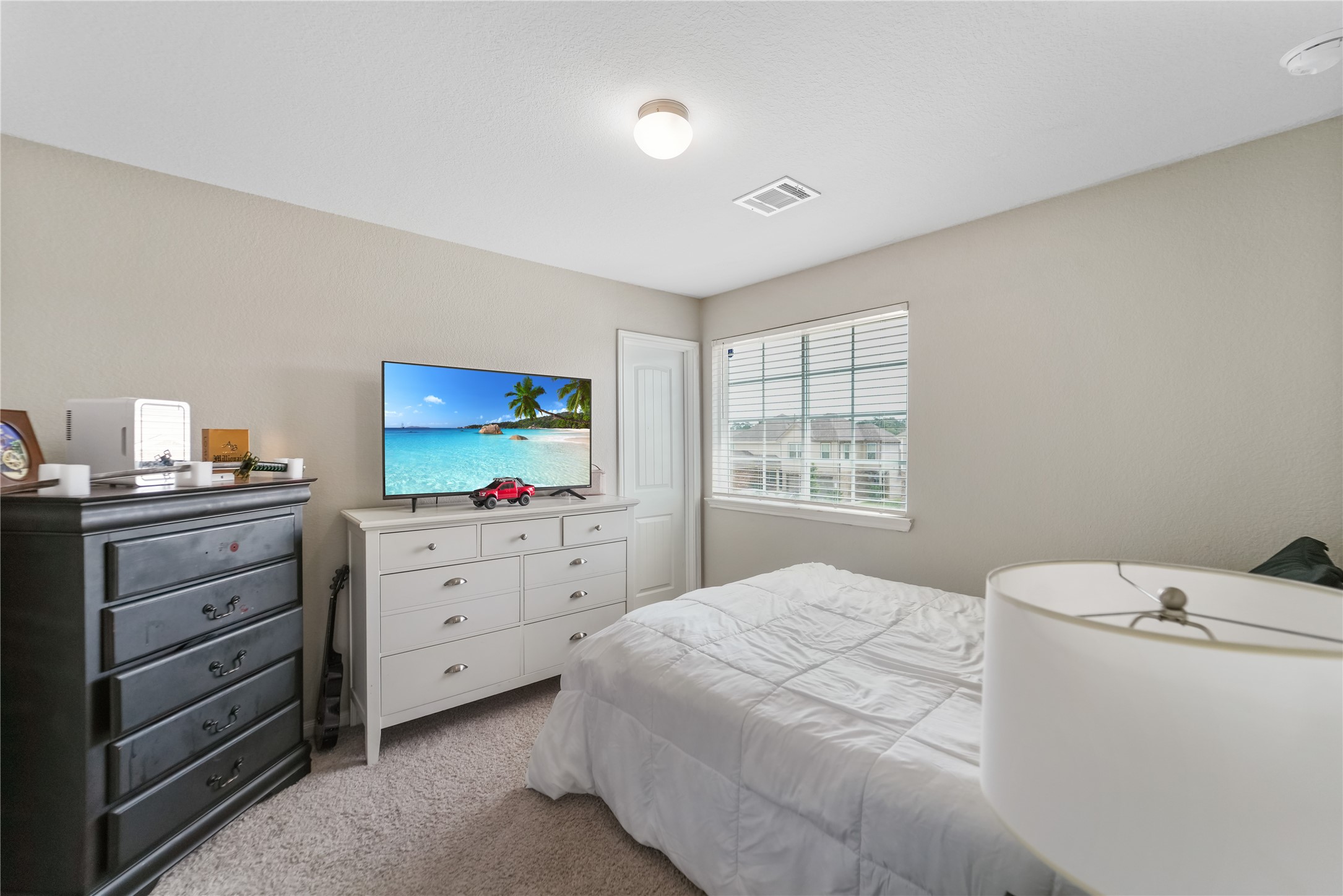 23659 Goodfellow Drive Spring, TX 77373 - Photo 19 of 25 a bedroom with a bed and a dresser
