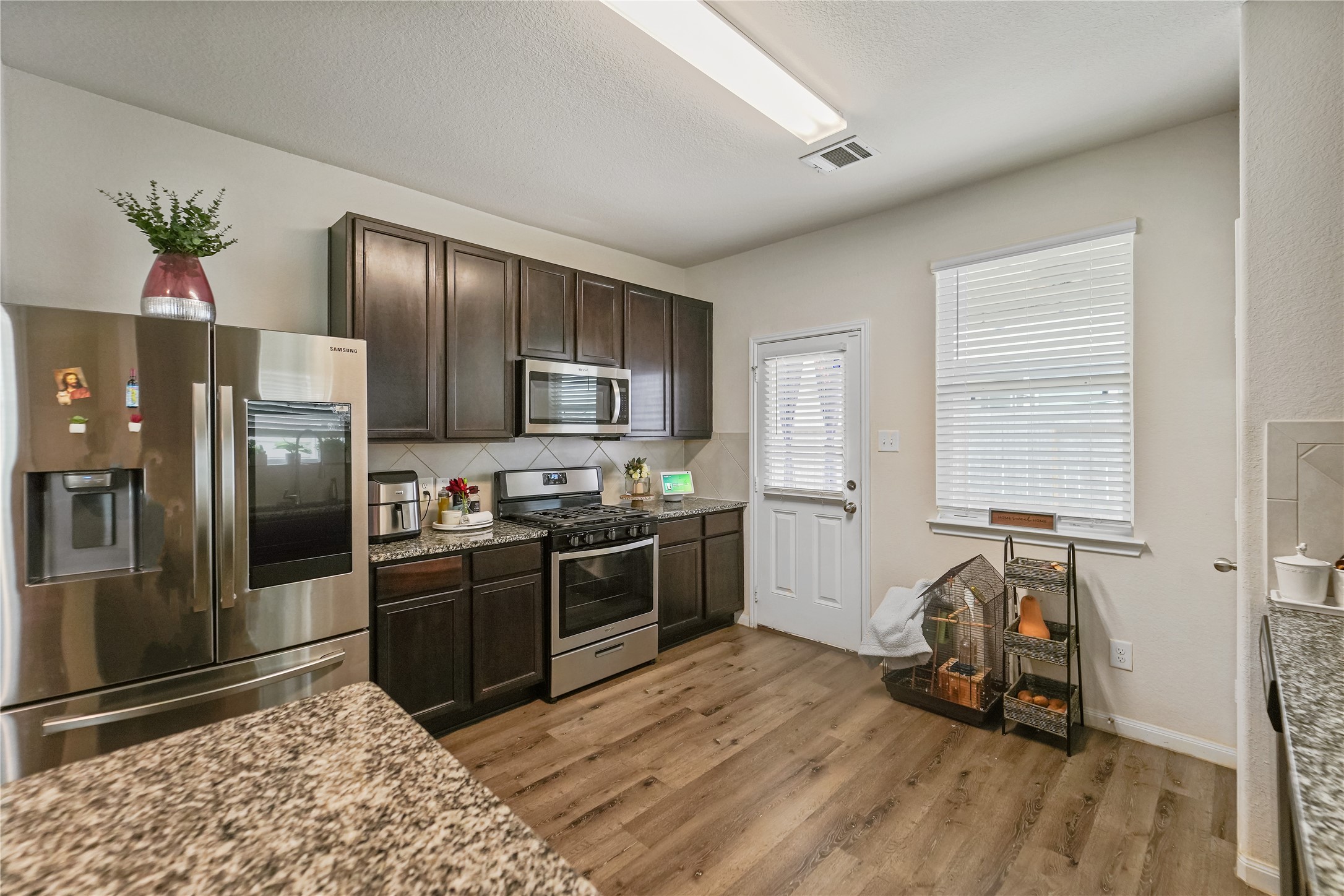 23659 Goodfellow Drive Spring, TX 77373 - Photo 7 of 25 a kitchen with stainless steel appliances granite countertop a refrigerator and a stove