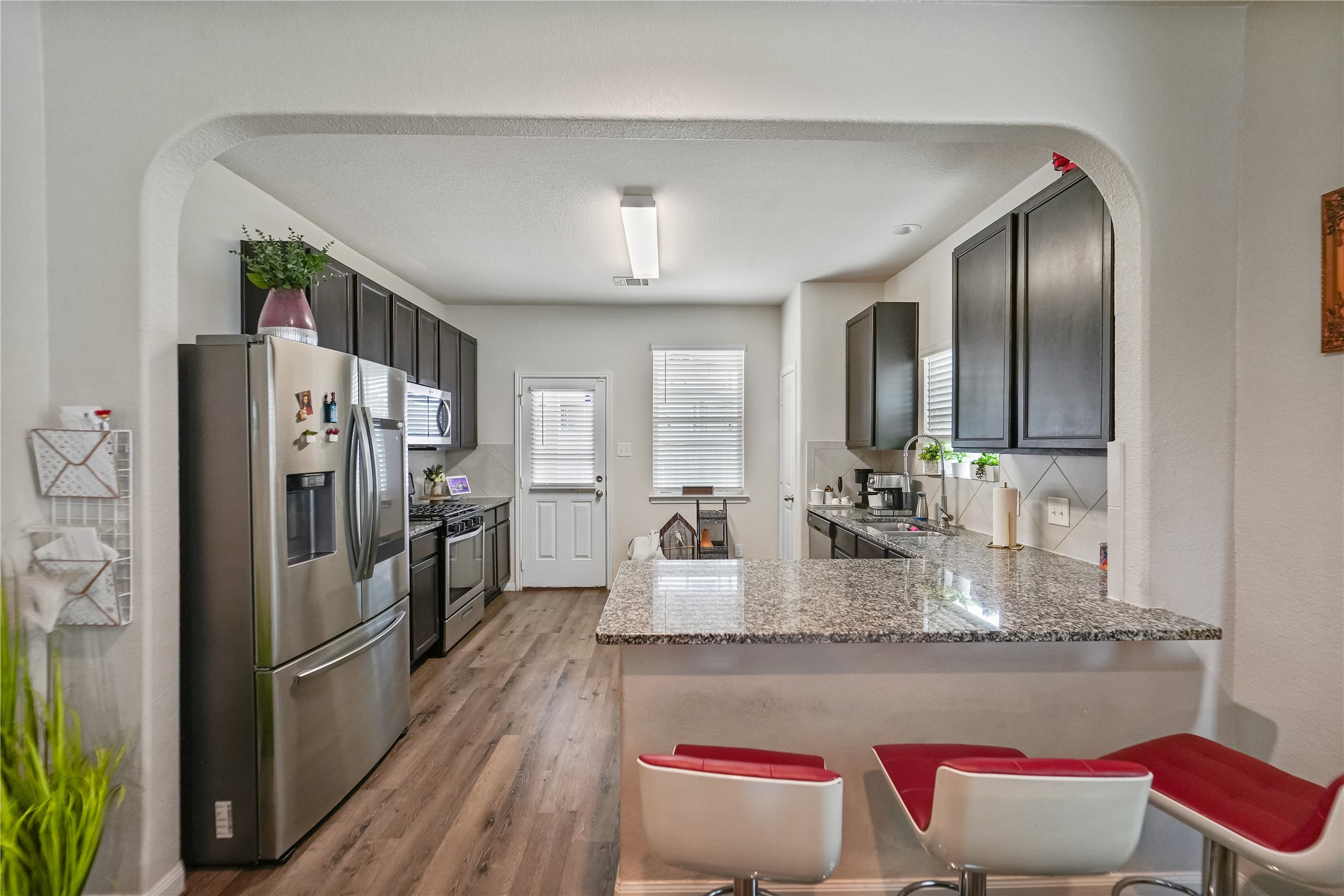 23659 Goodfellow Drive Spring, TX 77373 - Photo 10 of 25 a kitchen with refrigerator and stove