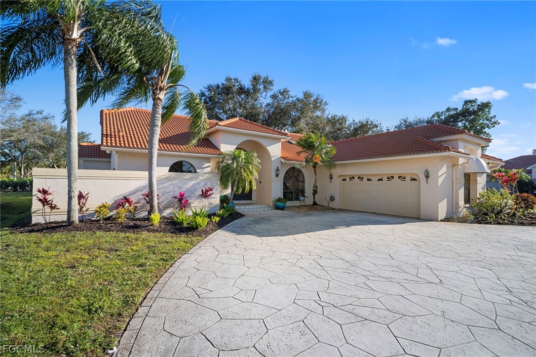 11772 Mahogany Run Fort Myers, FL 33913 - Photo 2 of 50 a front view of a house with a yard and garage