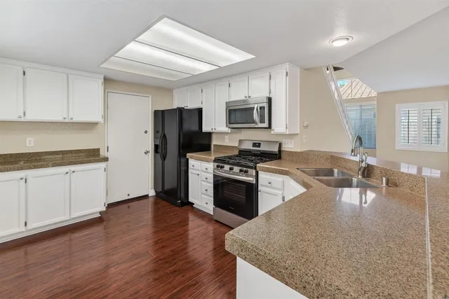 a kitchen with a stove a sink and a refrigerator