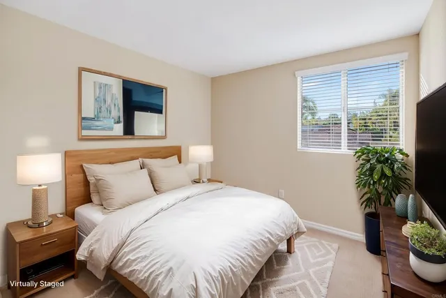 a bedroom with a bed and a potted plant