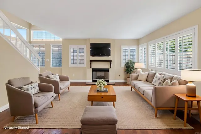 a living room with furniture fireplace and a flat screen tv