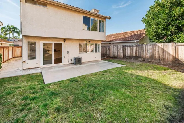 a view of a house with a yard and sitting area