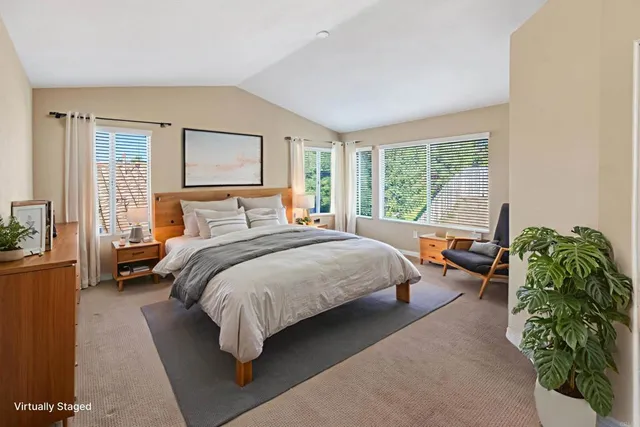 a bedroom with a bed and large window