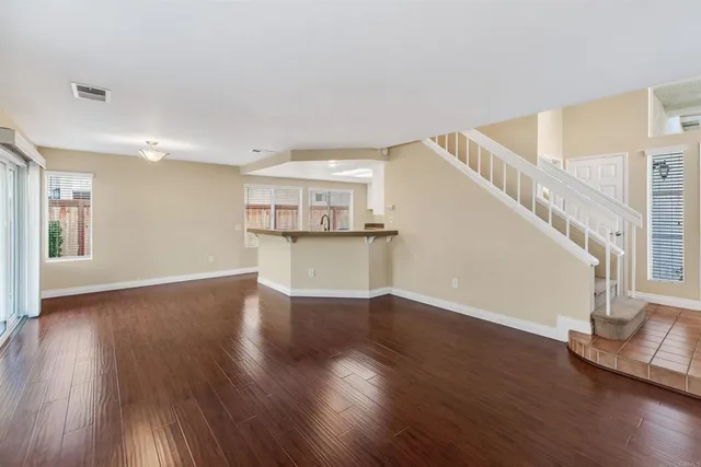 a view of a kitchen with wooden floor and electronic appliances