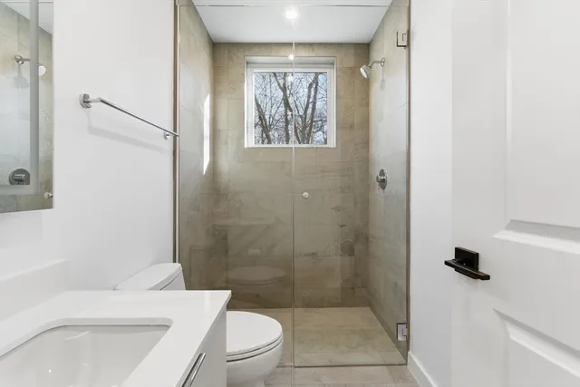 a bathroom with a toilet a sink and a shower