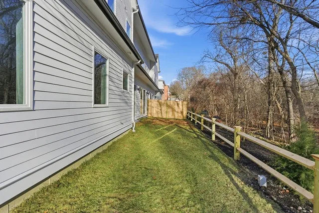 a view of a backyard with wooden fence