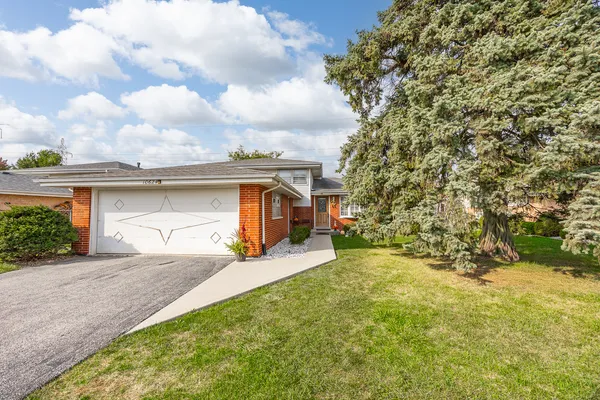 a view of a house with a yard and garage