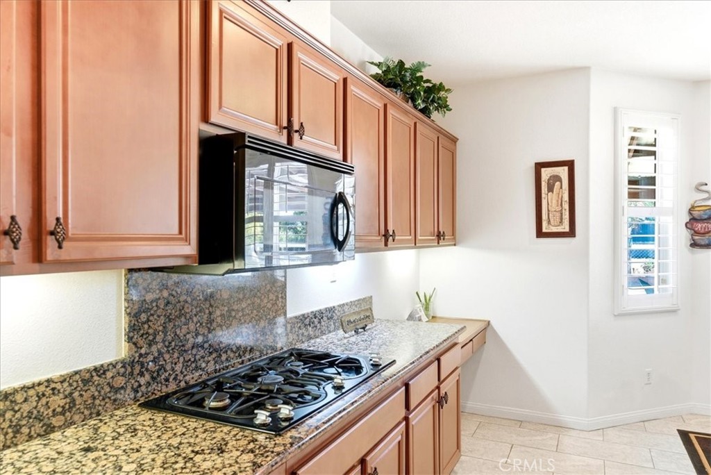 17715 Timberview Drive Riverside, CA 92504 - Photo 12 of 46 a kitchen with stainless steel appliances granite countertop a stove and a microwave