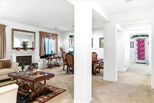 a living room with furniture fireplace and a large window