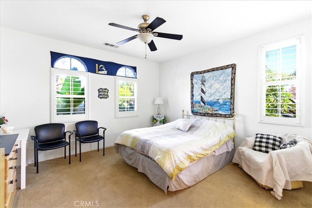 17715 Timberview Drive Riverside, CA 92504 - Photo 18 of 46 a bedroom with a bed and a couch