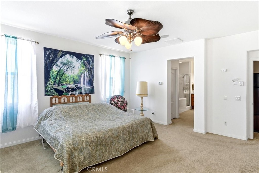 17715 Timberview Drive Riverside, CA 92504 - Photo 24 of 46 a bedroom with a large bed and a large window