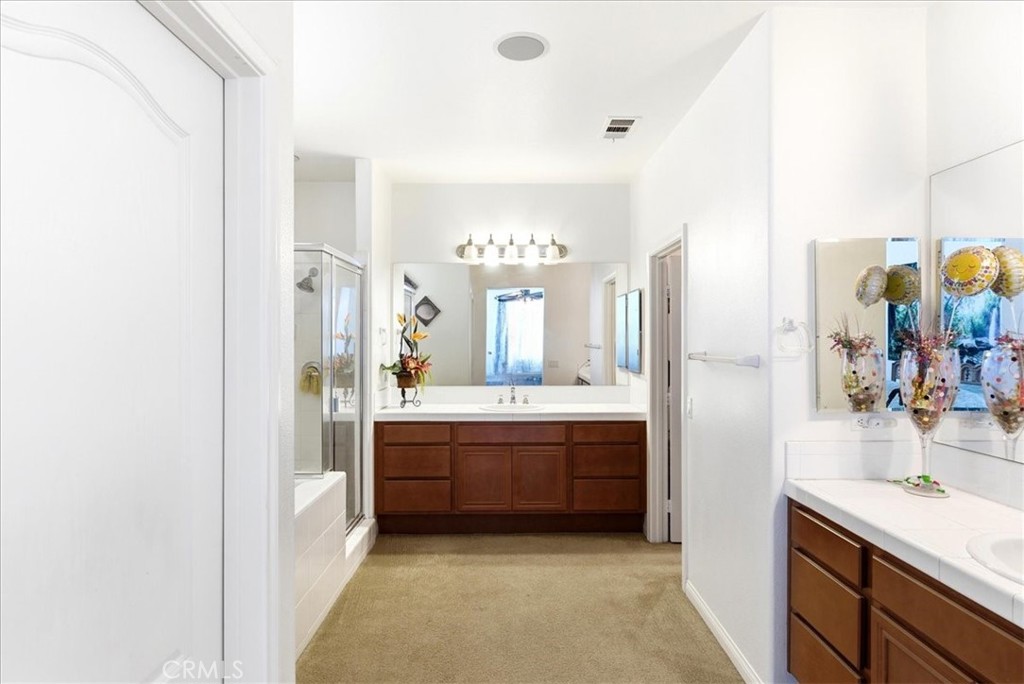 17715 Timberview Drive Riverside, CA 92504 - Photo 25 of 46 a bathroom with a tub sink and mirror