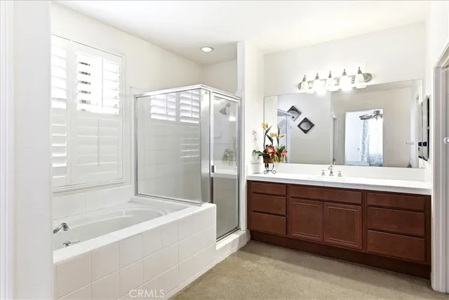 a bathroom with a tub sink and mirror