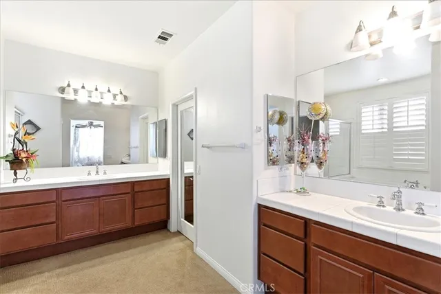 a spacious bathroom with a tub sink shower and mirror
