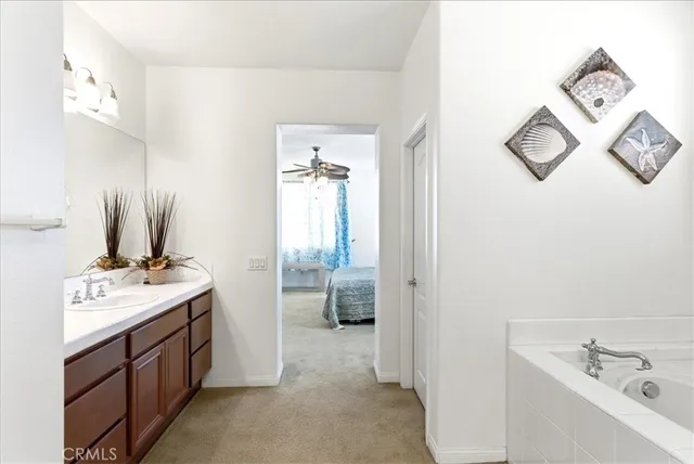 a bathroom with a tub sink and mirror