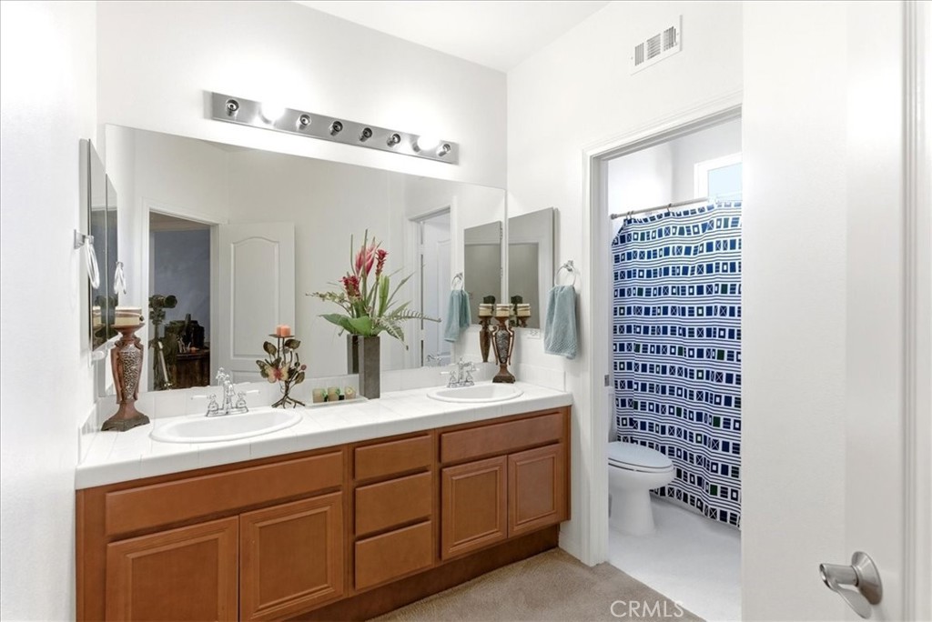17715 Timberview Drive Riverside, CA 92504 - Photo 31 of 46 a bathroom with a double vanity sink mirror and toilet