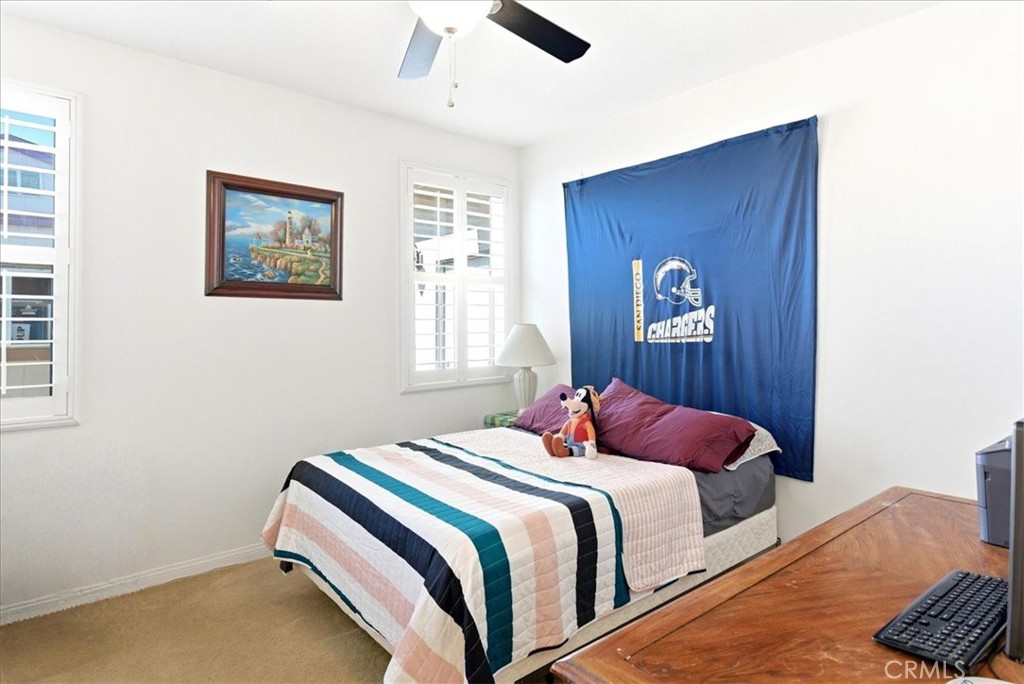 17715 Timberview Drive Riverside, CA 92504 - Photo 32 of 46 a bedroom with a bed and a lamp with window