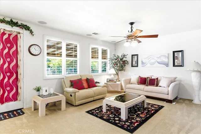 a living room with furniture a rug and a large window