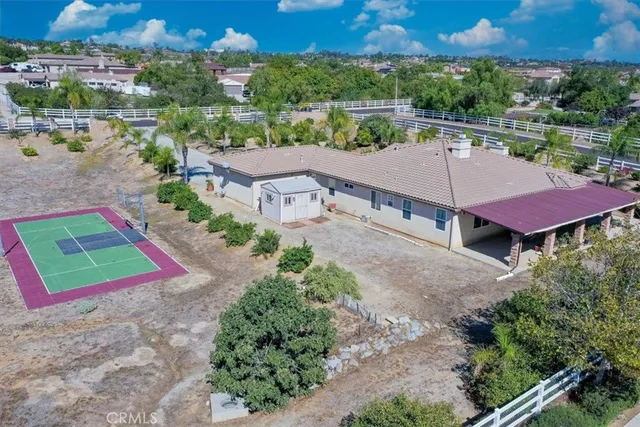 an aerial view of a house with a yard and lake view