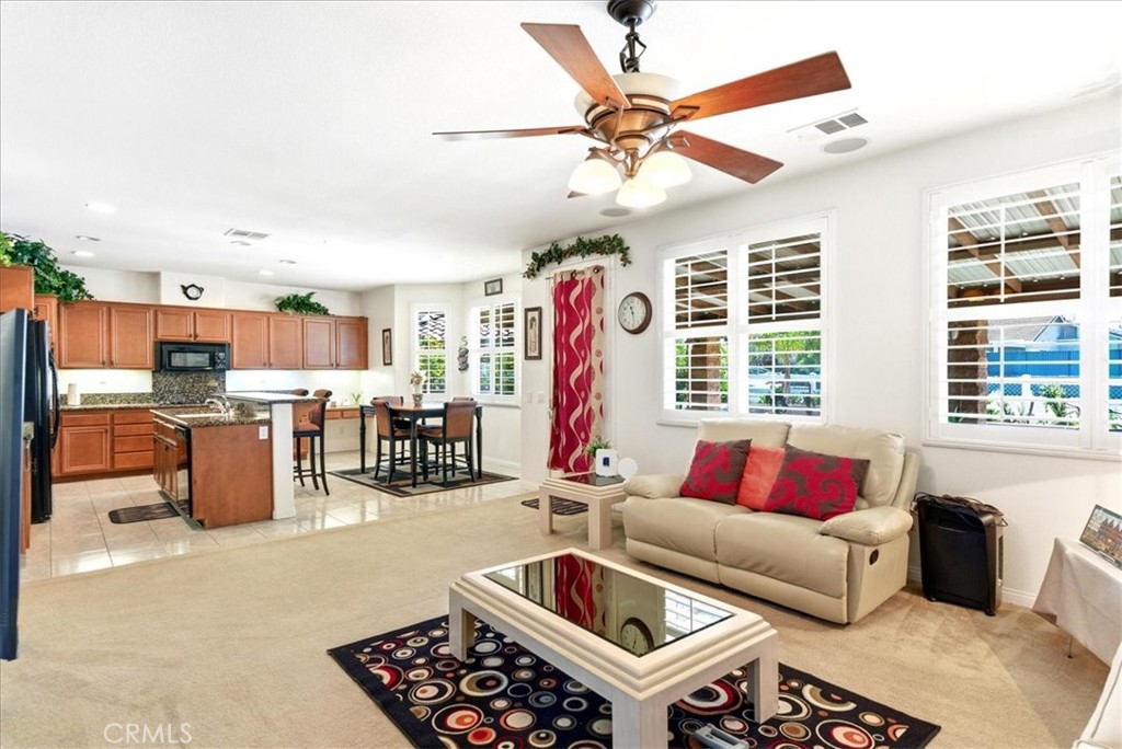 17715 Timberview Drive Riverside, CA 92504 - Photo 45 of 46 a living room with furniture kitchen view and a large window