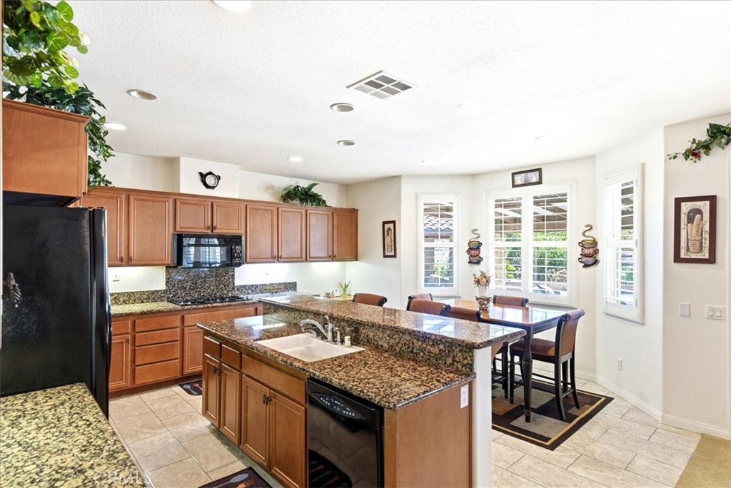 17715 Timberview Drive Riverside, CA 92504 - Photo 8 of 46 a kitchen with stainless steel appliances granite countertop a sink stove and refrigerator