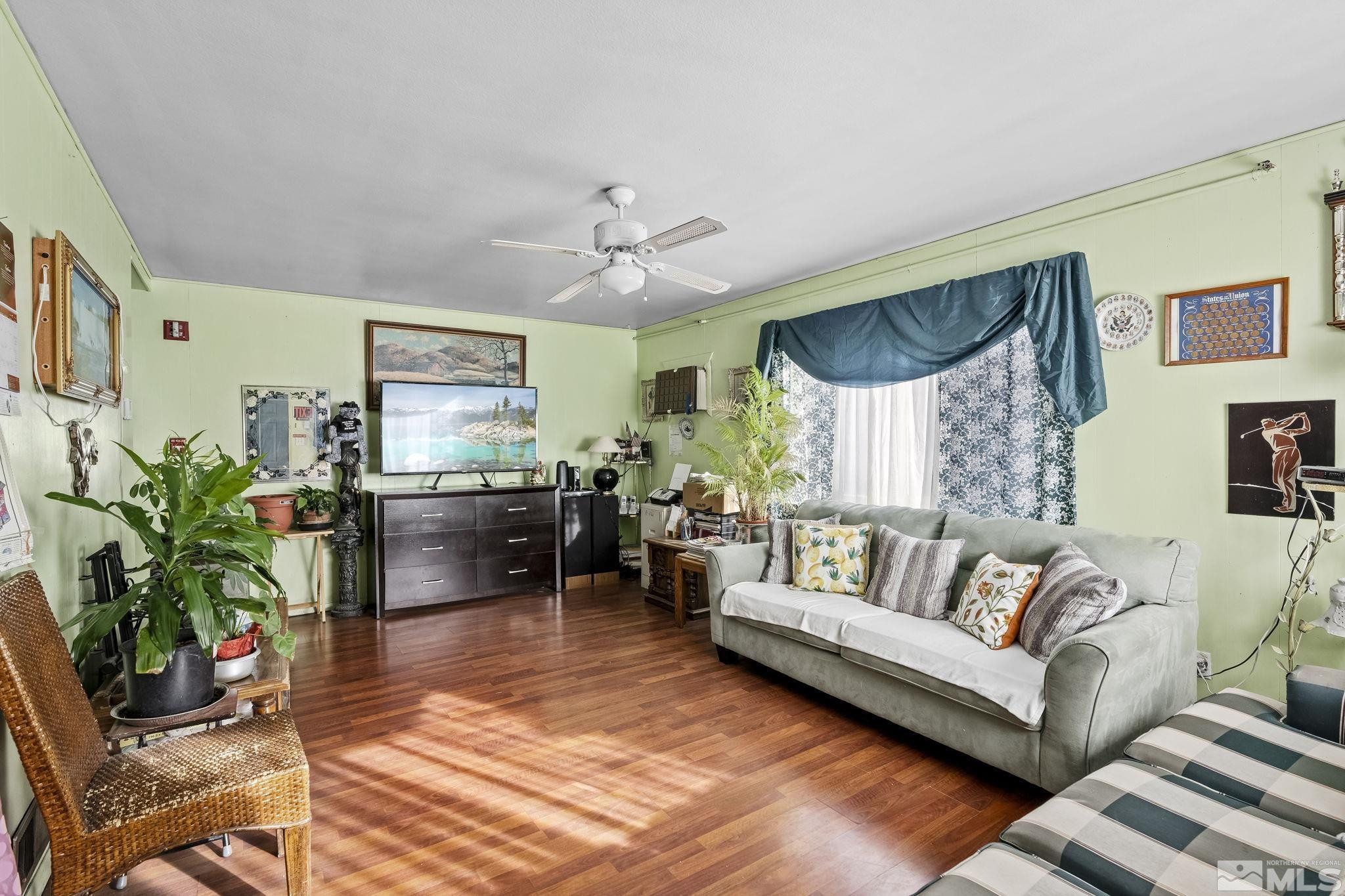 a living room with furniture kitchen view and a potted plant