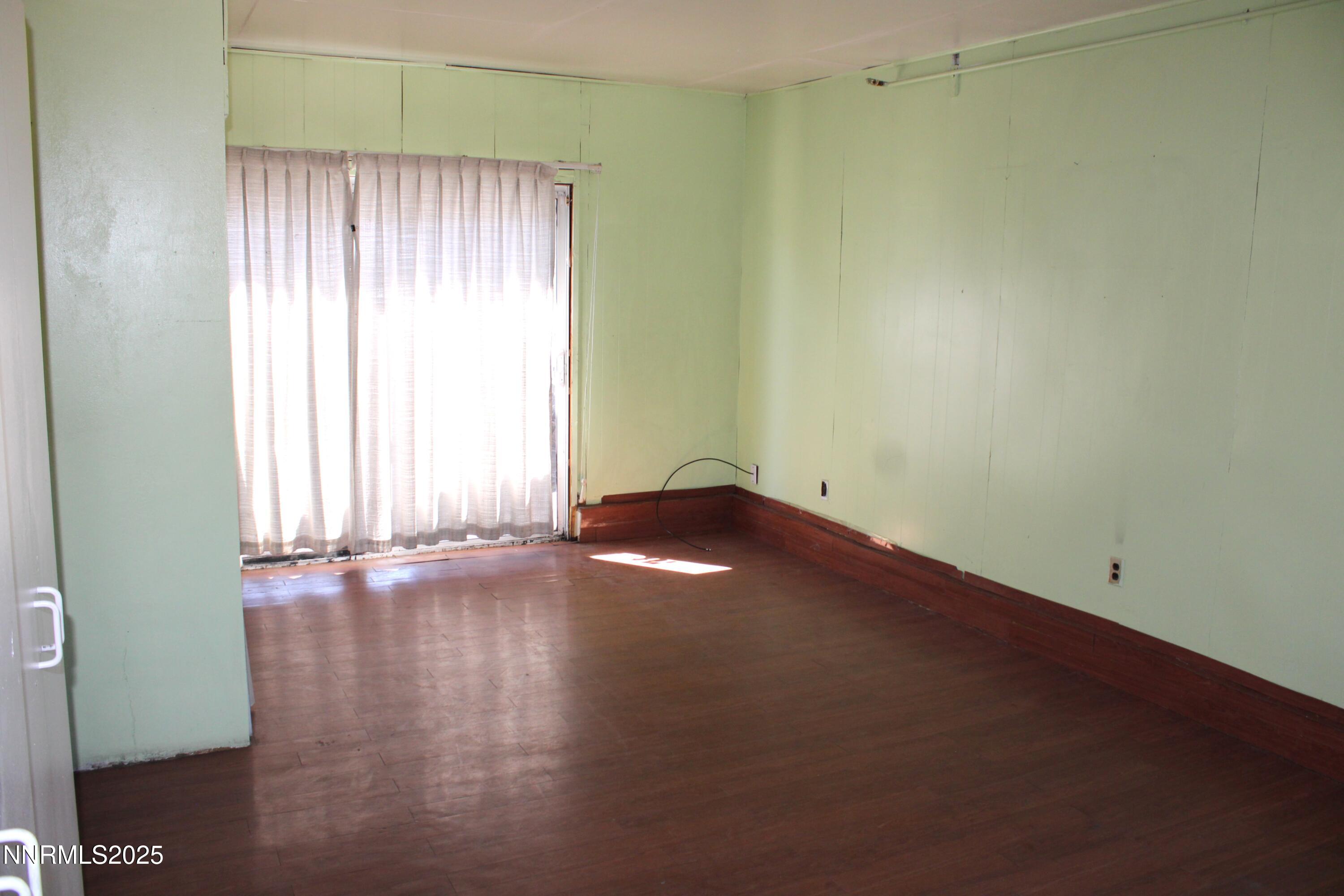 1885 Castle Way Reno, NV 89512 - Photo 12 of 18 an empty room with wooden floor and windows