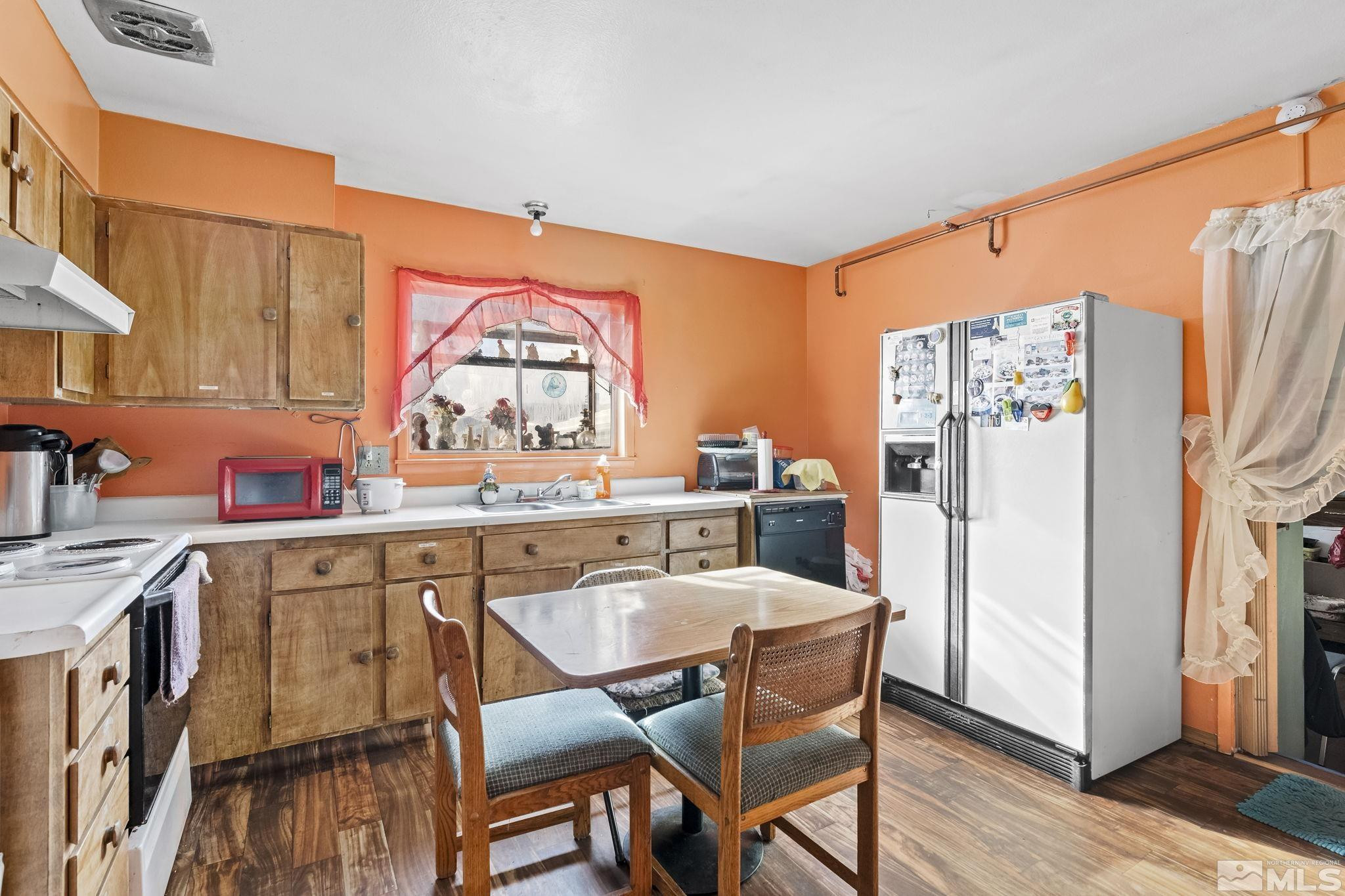 1885 Castle Way Reno, NV 89512 - Photo 5 of 18 a dining hall with stainless steel appliances granite countertop a refrigerator and a stove top oven