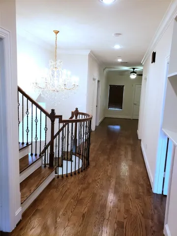 a view of a livingroom with wooden floor and chandelier