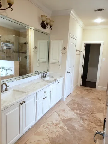 a spacious bathroom with a double vanity sink and mirror