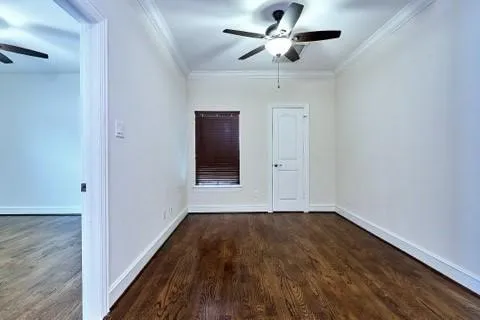 a view of a hallway with wooden floor and a cabinet