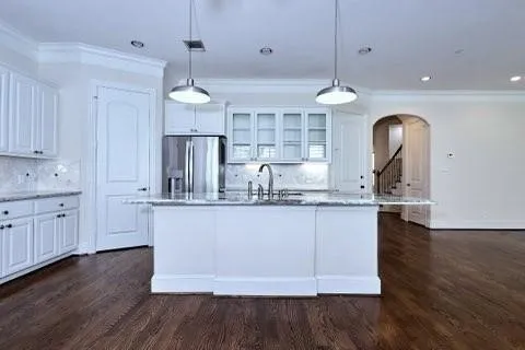 a kitchen with center island wooden floor and stainless steel appliances
