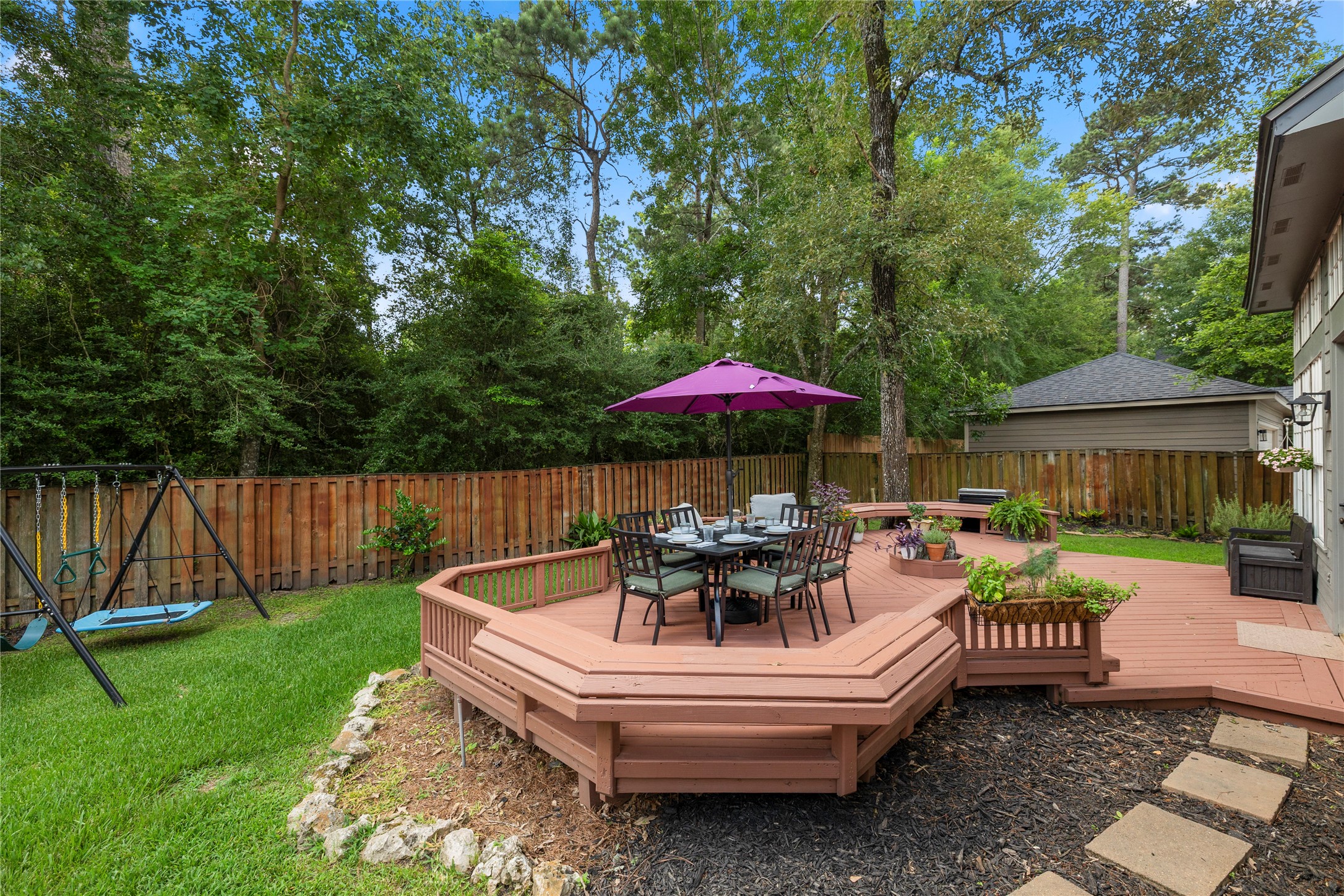 102 Treescape Circle Spring, TX 77381 - Photo 27 of 40 This home showcases a spacious backyard with a wooden deck, backyard completely fenced and nestled in the trees!