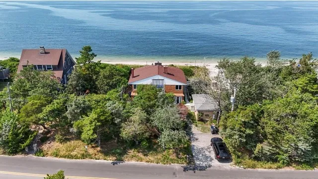 an aerial view of a house with a yard