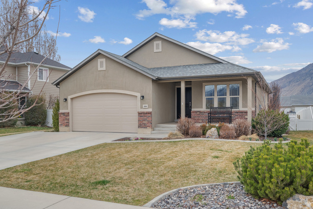 1896 West 800 North Mapleton, UT 84663 - Photo 55 of 55 View of front of house featuring brick siding, covered porch, stucco siding, an attached garage, and driveway