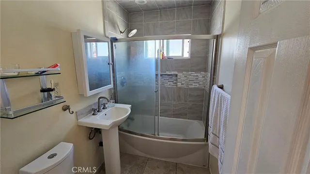 a view of a balcony with wooden floor and fence