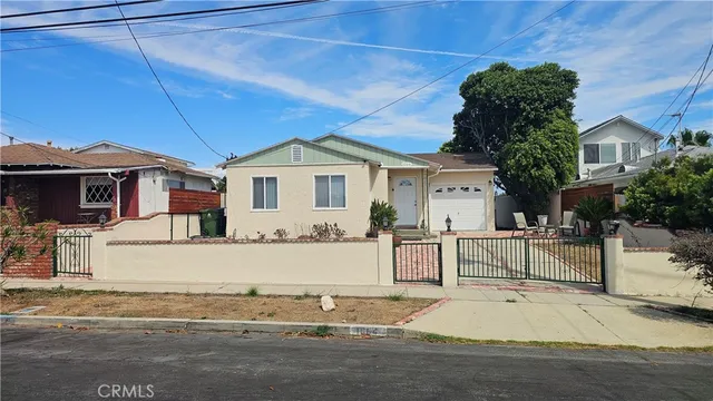 a front view of a house with a garden and patio