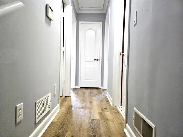 a view of a hallway with wooden floor