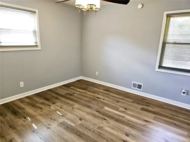 a view of a room with wooden floor and window
