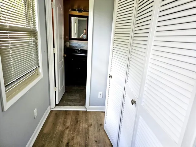 a view of a hallway with wooden floor and staircase